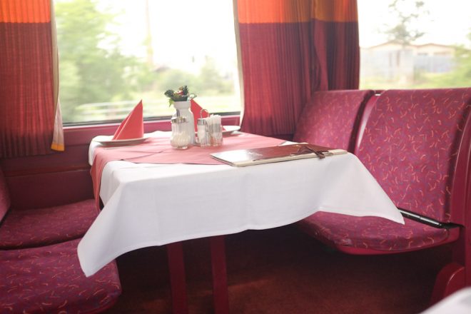 I love the formality of the dining car, and how it collides with practicality, like the menus covered in plastic to protect from inevitable spills